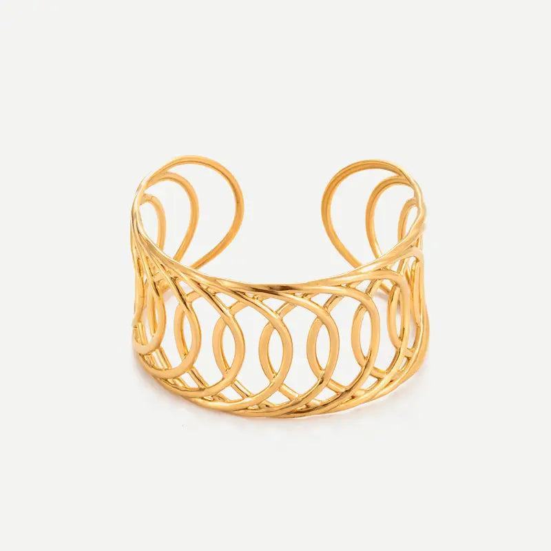 A gold-toned open cuff bracelet with an intricate, interlocking circular lattice pattern, shown on a clean off-white background.